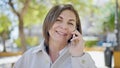 Middle age hispanic woman speaking on the phone at park Royalty Free Stock Photo