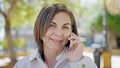 Middle age hispanic woman speaking on the phone at park Royalty Free Stock Photo
