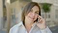 Middle age hispanic woman speaking on the phone at street Royalty Free Stock Photo