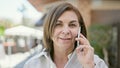 Middle age hispanic woman speaking on the phone at street Royalty Free Stock Photo