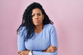 Middle age hispanic woman standing over pink background shaking and freezing for winter cold with sad and shock expression on face Royalty Free Stock Photo