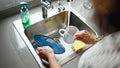 Middle age hispanic woman washing plates at the kitchen Royalty Free Stock Photo