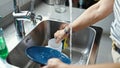 Middle age hispanic woman washing plates at the kitchen Royalty Free Stock Photo