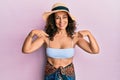 Middle age hispanic woman wearing bikini and summer hat looking confident with smile on face, pointing oneself with fingers proud Royalty Free Stock Photo