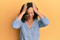 Middle age hispanic woman wearing casual clothes suffering from headache desperate and stressed because pain and migraine Royalty Free Stock Photo