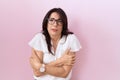 Middle age hispanic woman wearing casual white t shirt and glasses shaking and freezing for winter cold with sad and shock Royalty Free Stock Photo