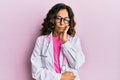 Middle age hispanic woman wearing doctor uniform and glasses thinking looking tired and bored with depression problems with Royalty Free Stock Photo