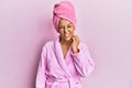 Middle age hispanic woman wearing shower towel cap and bathrobe touching mouth with hand with painful expression because of Royalty Free Stock Photo