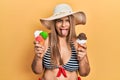 Middle age hispanic woman wearing summer style holding ice cream sticking tongue out happy with funny expression Royalty Free Stock Photo