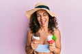 Middle age hispanic woman wearing summer style holding ice cream winking looking at the camera with sexy expression, cheerful and Royalty Free Stock Photo