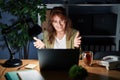 Middle age hispanic woman working using computer laptop at night looking at the camera smiling with open arms for hug Royalty Free Stock Photo