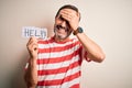 Middle age hoary man holding paper with help message over isolated white background stressed with hand on head, shocked with shame Royalty Free Stock Photo