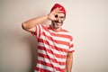 Middle age hoary man wearing striped t-shirt glasses and cap over isolated white background doing ok gesture with hand smiling, Royalty Free Stock Photo