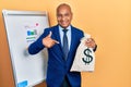 Middle age latin man wearing business suit holding dollars bag pointing finger to one self smiling happy and proud Royalty Free Stock Photo