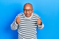 Middle age latin man wearing casual clothes and glasses excited for success with arms raised and eyes closed celebrating victory Royalty Free Stock Photo