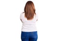 Middle age latin woman wearing casual white tshirt standing backwards looking away with crossed arms