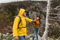 Loving couple with backpack hiking in a beautiful nature. Helping hand - hiker woman getting help on hike Royalty Free Stock Photo