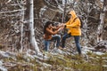 Couple with backpack hiking in a beautiful nature. Helping hand - hiker woman getting help on hike Royalty Free Stock Photo