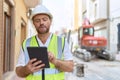 Middle age man architect using touchpad at street