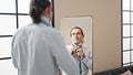 Middle age man business worker looking on mirror wearing tie at home Royalty Free Stock Photo