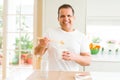 Middle age man eating take away noodles with choopsticks at home Royalty Free Stock Photo