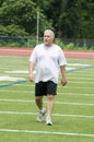 Middle age man exercising on sports field Royalty Free Stock Photo