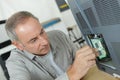 middle age man fixing electronic circuits closeup