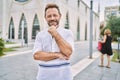 Middle age man outdoor at the city looking confident at the camera smiling with crossed arms and hand raised on chin Royalty Free Stock Photo