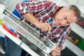 middle-age man plumber fixing radiator Royalty Free Stock Photo