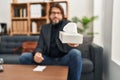 Middle age man psychologist holding napkin at psychology clinic Royalty Free Stock Photo