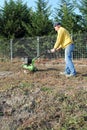 Middle age man with a rototiller Royalty Free Stock Photo
