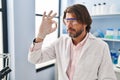 Middle age man scientist holding pill at laboratory Royalty Free Stock Photo