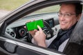 Middle age man shows smartphone with chromakey screen Royalty Free Stock Photo