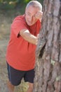 middle age man stretching legs outdoors doing forward lunge Royalty Free Stock Photo