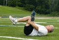 Middle age man stretching on sports field Royalty Free Stock Photo