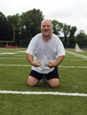 Middle age man stretching sports field Royalty Free Stock Photo