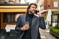 Middle age man talking on smartphone drinking coffee at street Royalty Free Stock Photo