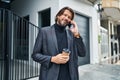 Middle age man talking on smartphone drinking coffee at street Royalty Free Stock Photo