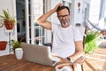 Middle age man using computer laptop at home confuse and wondering about question Royalty Free Stock Photo