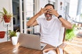 Middle age man using computer laptop at home covering eyes with hands smiling cheerful and funny Royalty Free Stock Photo