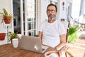 Middle age man using computer laptop at home making fish face with lips, crazy and comical gesture Royalty Free Stock Photo