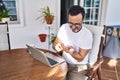 Middle age man using laptop taking pills at terrace home Royalty Free Stock Photo