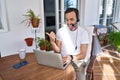 Middle age man wearing call center agent headset working from home pointing thumb up to the side smiling happy with open mouth Royalty Free Stock Photo