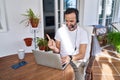 Middle age man wearing call center agent headset working from home smiling happy pointing with hand and finger to the side Royalty Free Stock Photo