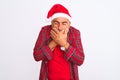 Middle age man wearing Christmas Santa hat standing over isolated white background shocked covering mouth with hands for mistake Royalty Free Stock Photo