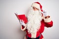 Middle age man wearing Santa Claus costume reading book over isolated white background smiling and confident gesturing with hand Royalty Free Stock Photo