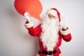 Middle age man wearing Santa costume holding speech bubble over isolated white background doing ok sign with fingers, excellent Royalty Free Stock Photo