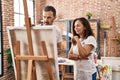 Middle age man and woman artists drawing at art studio