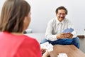 Middle age man and woman couple smiling confident playing poker cards at home Royalty Free Stock Photo