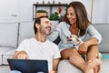 Middle age man and woman couple using laptop sitting on sofa with chihuahua at home Royalty Free Stock Photo